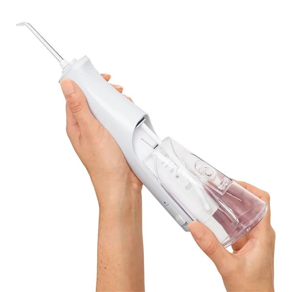 Sliding the removable reservoir away from the handle.
