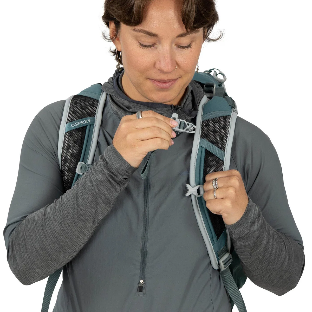 Blue same-model harness detail and sternum strap demonstration.