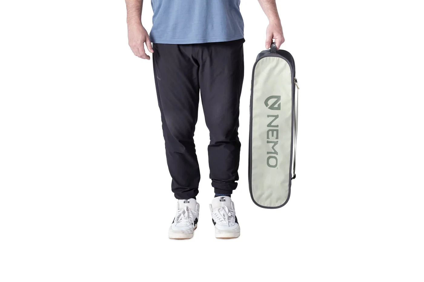 Marsh chair packed in its included carrying case, shown next to a person for scale.