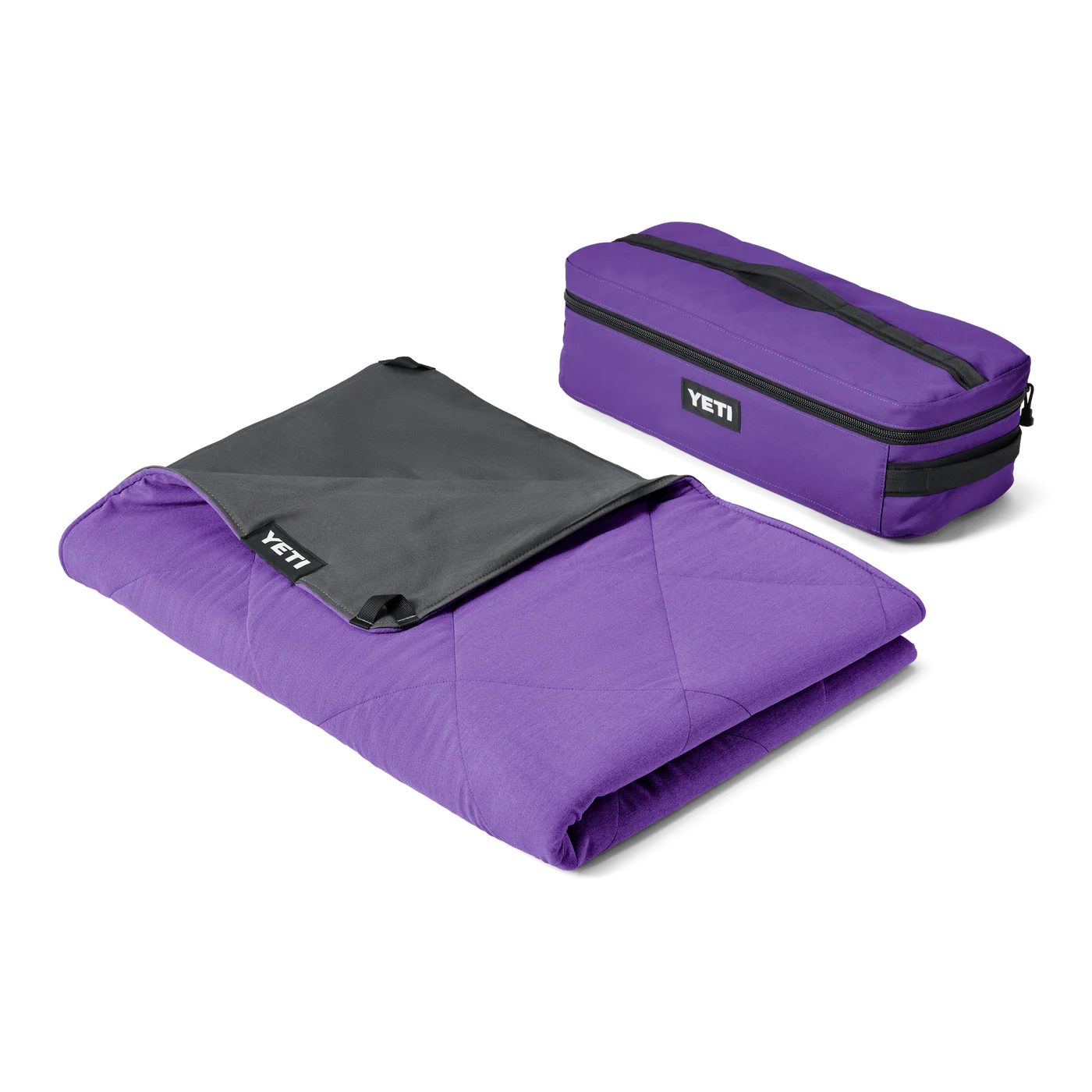 Selected Pace Purple Lowlands blanket beside its matching bag.