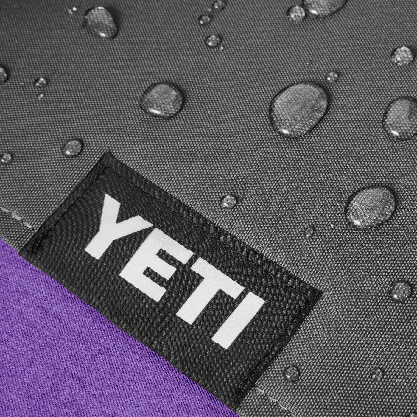 Ground-facing layer close-up with water droplets, a maker reference image.
