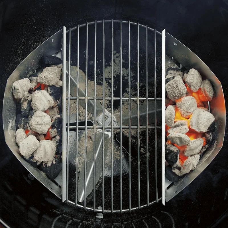 Two-side fuel arrangement in a Weber grill; grill and grates are separate.