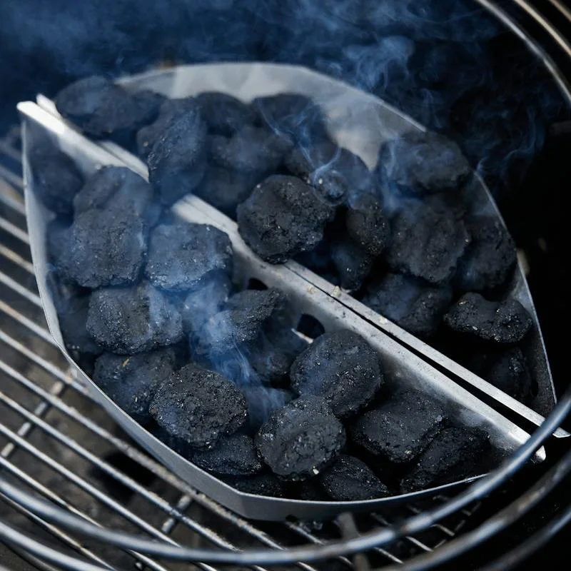 Maker charcoal-loading scene in another Weber grill; confirm your own model compatibility.