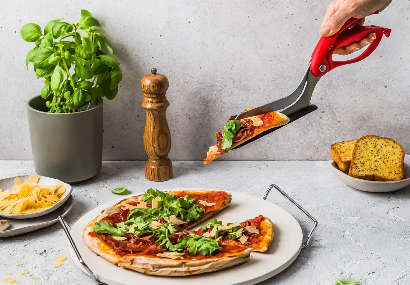 Red Scizza lifting a portion with its serving shoe.