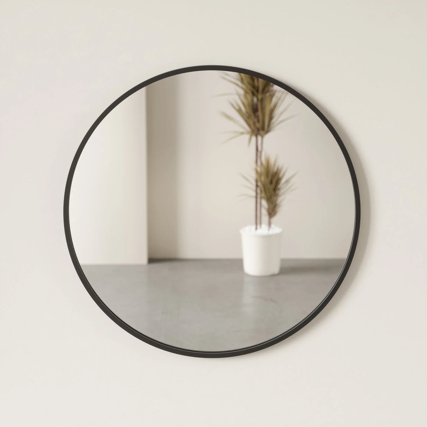 Black rubber-edged mirror showing how the surrounding room appears in reflection.