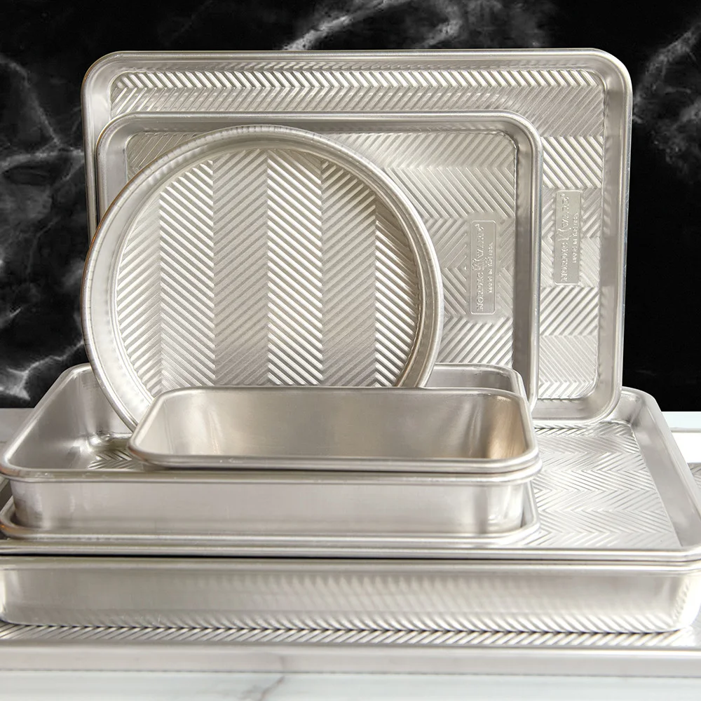 Prism family stacked in several shapes; only the selected high-sided pan is supplied.