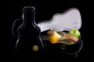 Open tin containing wrapped food and fruit; food and wrapping are separate.