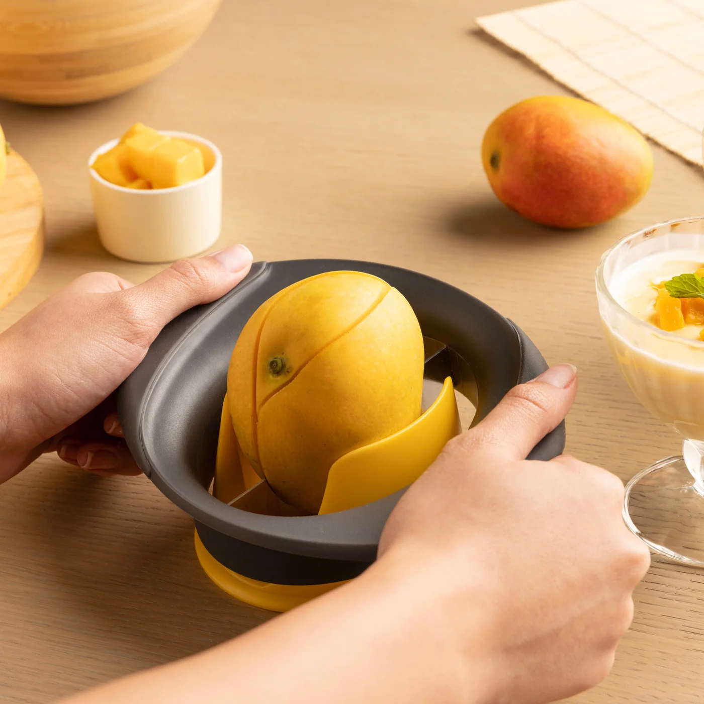 Cutter aligned over a mango in the support holder.
