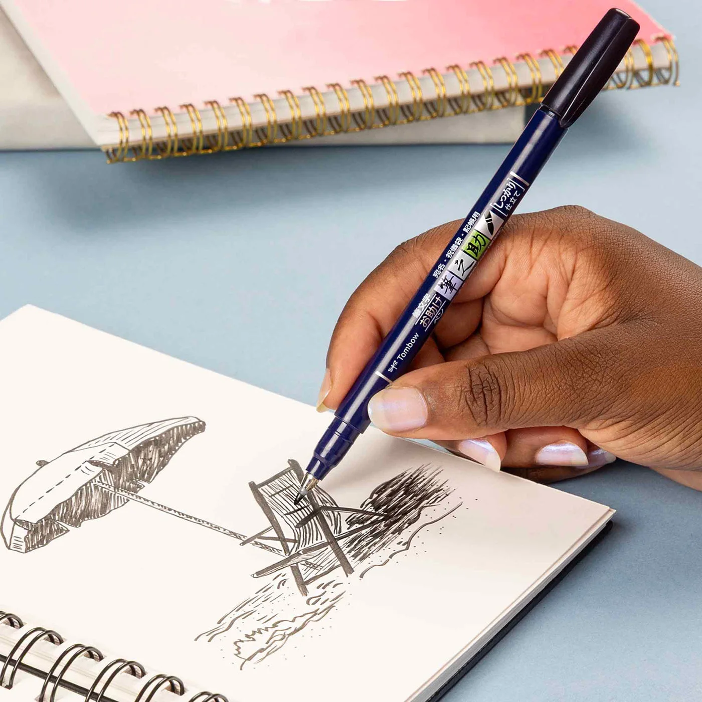Drawing example with the black pen; sketchbook and surroundings are not supplied.