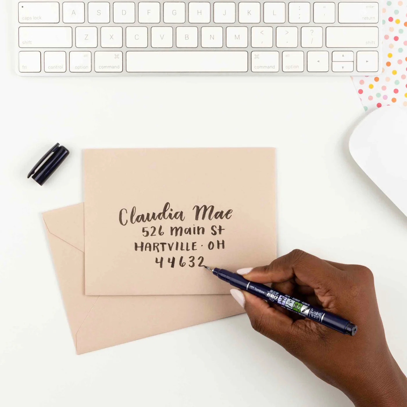 Envelope-addressing example; envelope and desk accessories are not included.