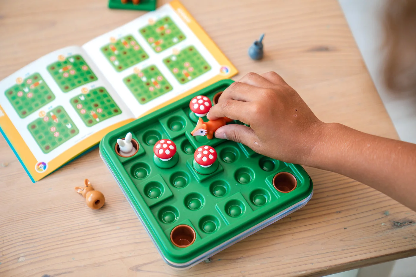 Close-up of figures being arranged to match a challenge booklet.