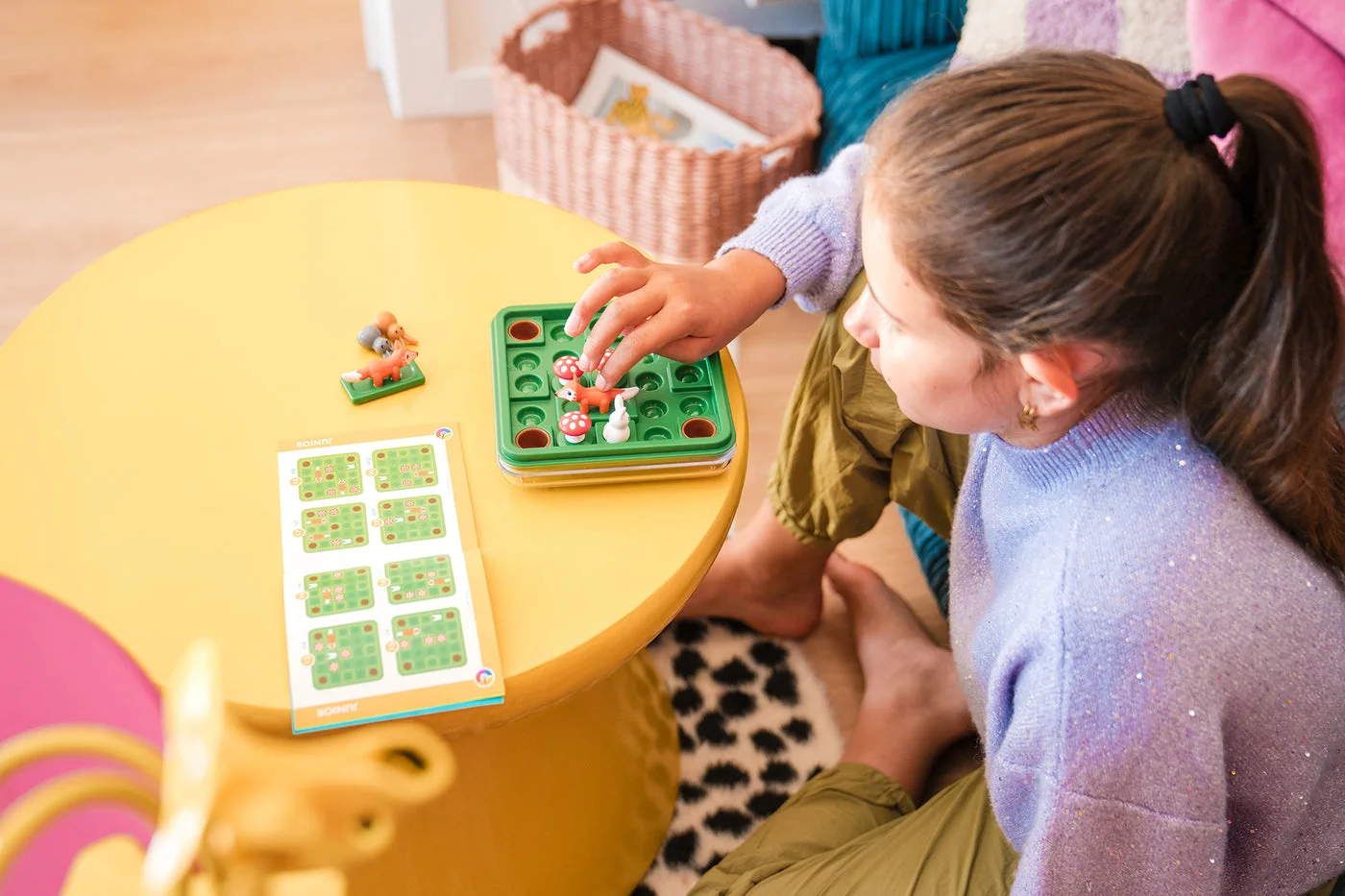 Child examining the board beside a challenge booklet.