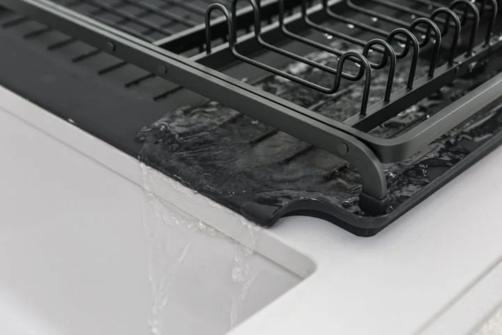 Tray outlet shown draining toward the sink; check your sink lip and height.