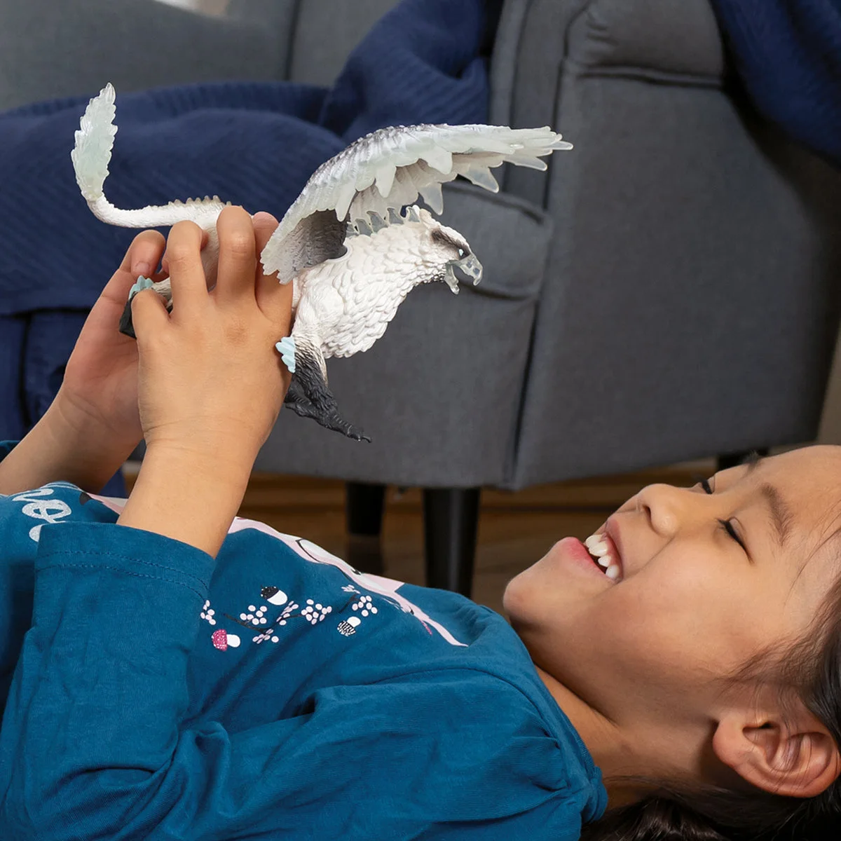 Child holding the figure in a manufacturer lifestyle scene.