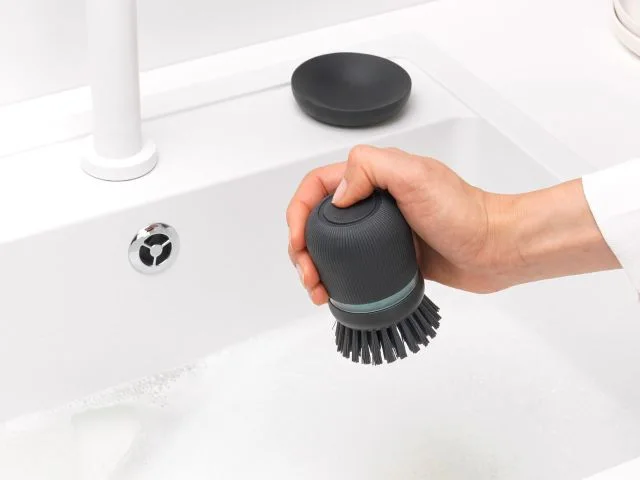 Button and grip shown in the manufacturer’s use scene.