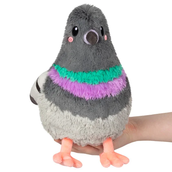 Mini Pigeon front view with a human-held scale reference.