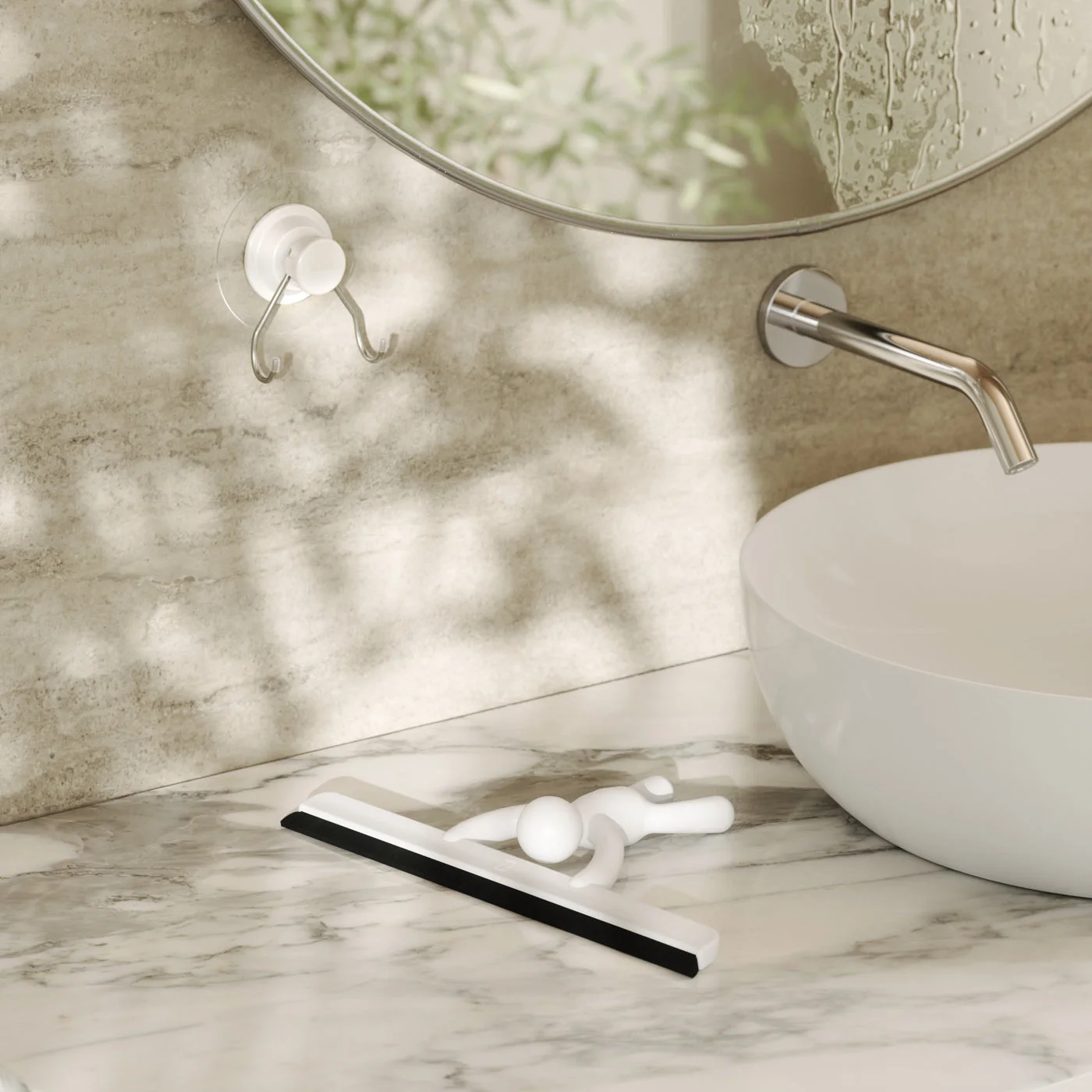 Squeegee resting beside a basin in a staged maker scene.
