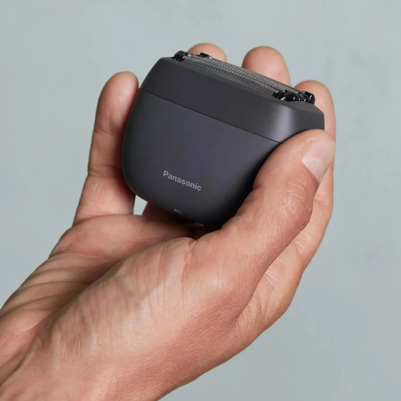 Black palm-held format illustrating the grip rather than a conventional long handle.