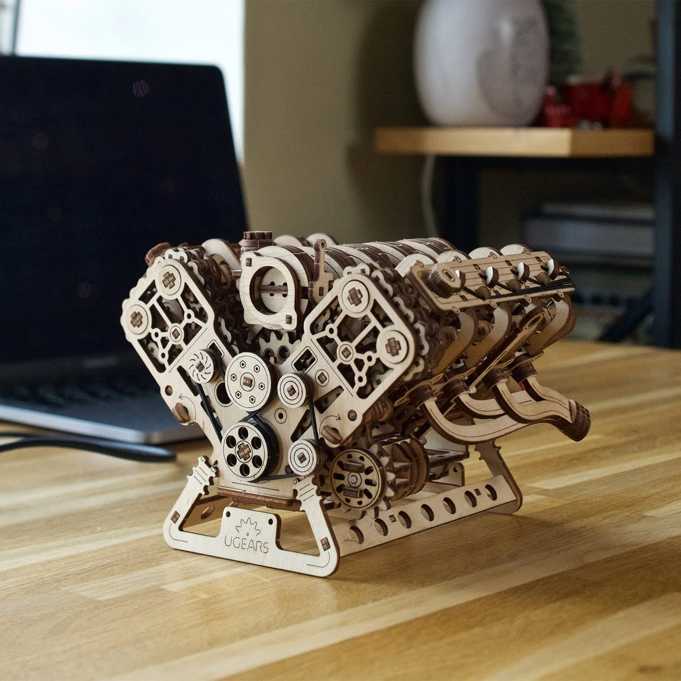 Finished V8 model on a desk; laptop and other setting items are separate.