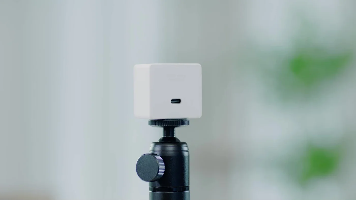 A white-finish Meet 2 on a separately arranged tripod; the selected finish is grey and a tripod is not promised.