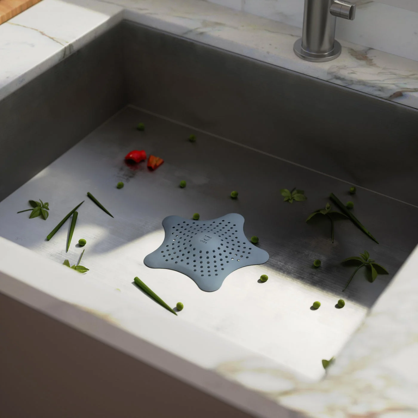 Maker drain-use scene with selected Slate Blue Starfish; sink fixtures and debris are illustrative and not included.