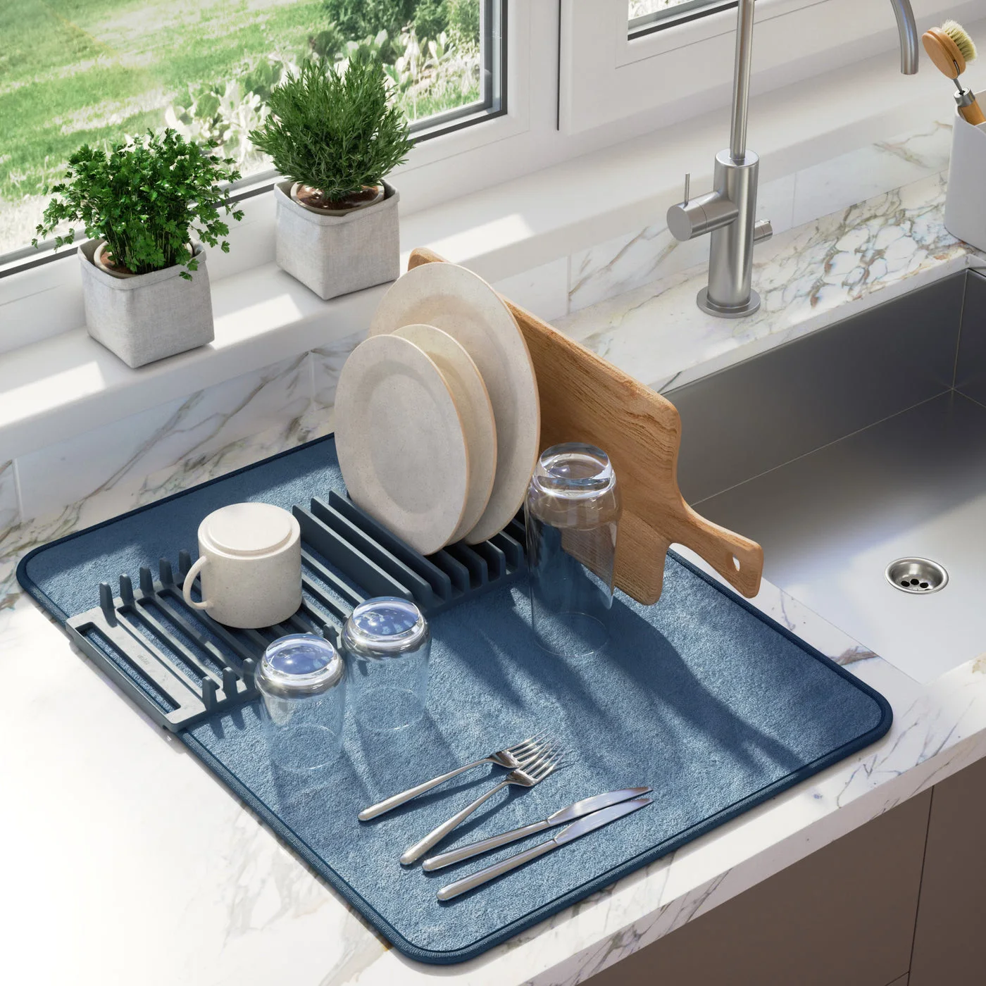 Rack-and-mat placement beside a sink; cups and utensils are separate.