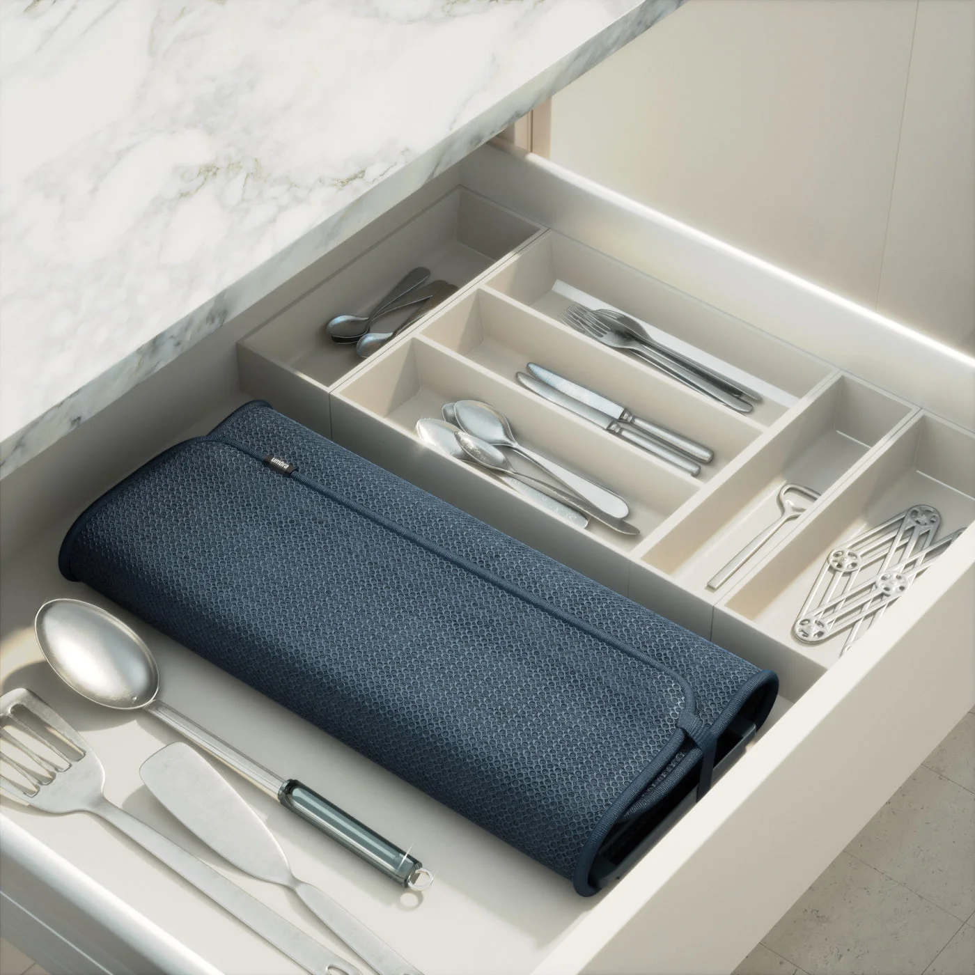 Folded mat and rack stored in a drawer; surrounding utensils are not included.