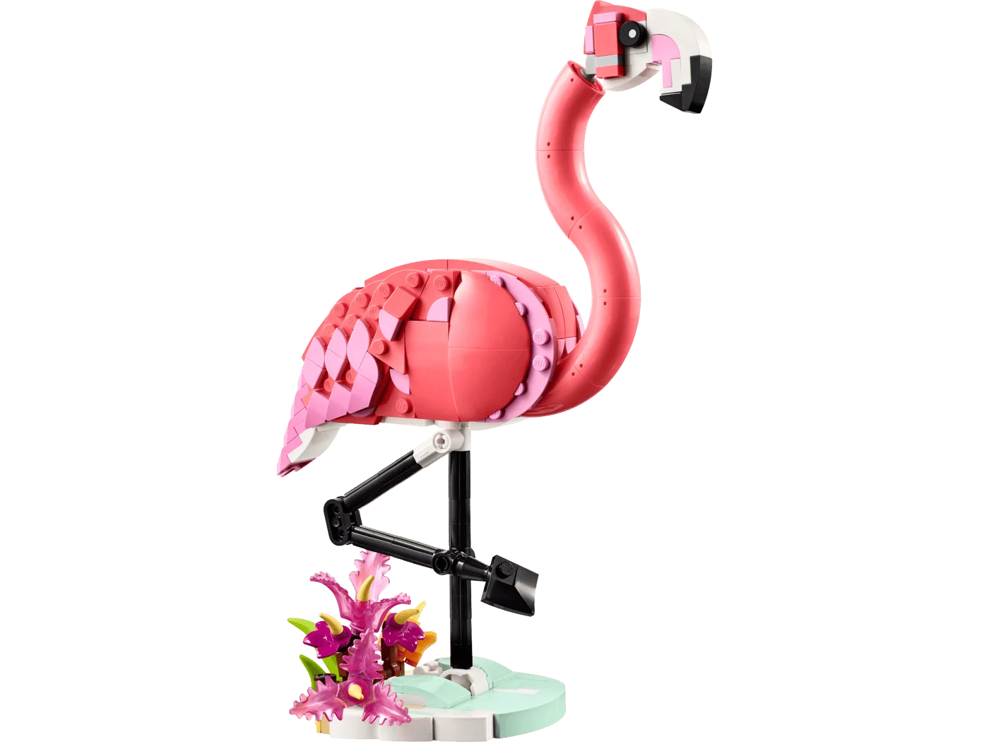 Pink flamingo standing on its plant-covered base.