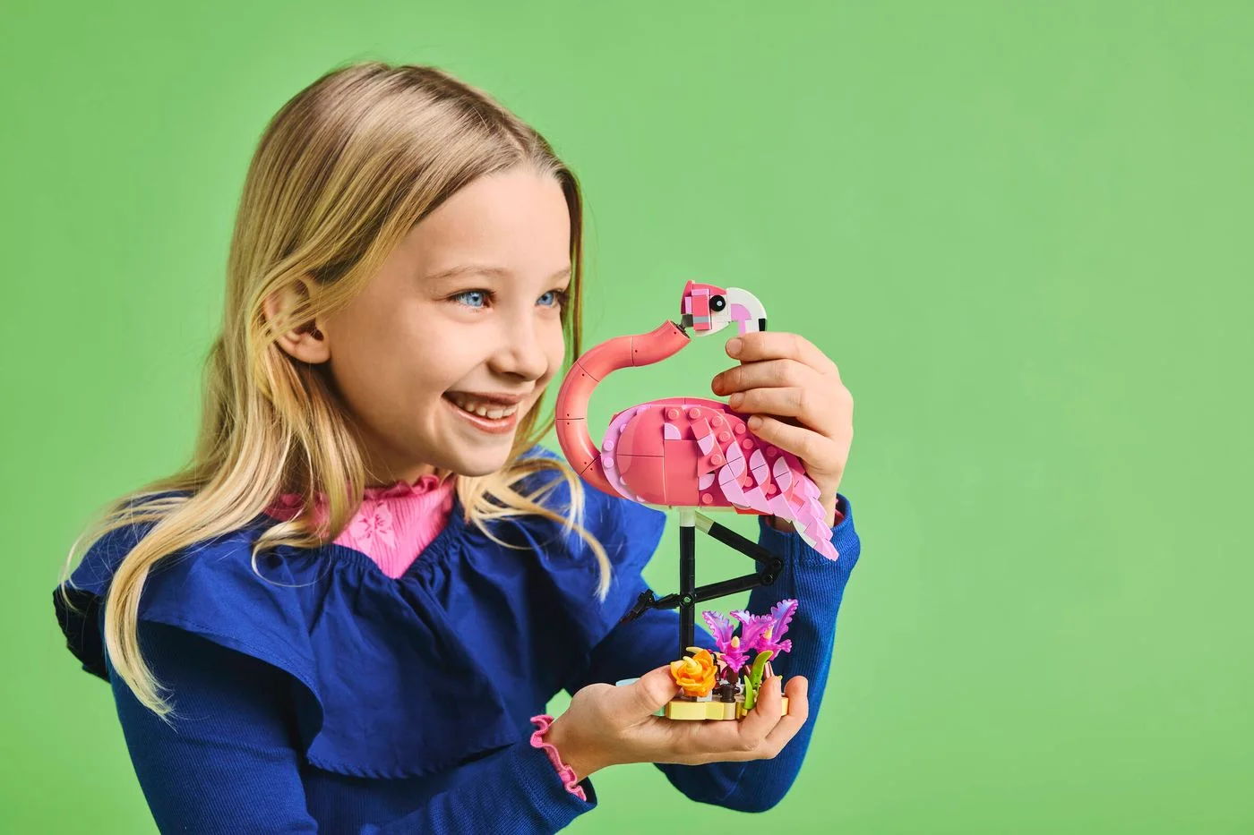 Manufacturer scene showing the flamingo held for scale.