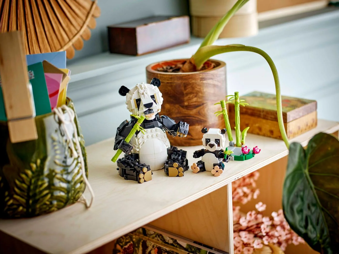 Panda family displayed on a shelf with surrounding space.
