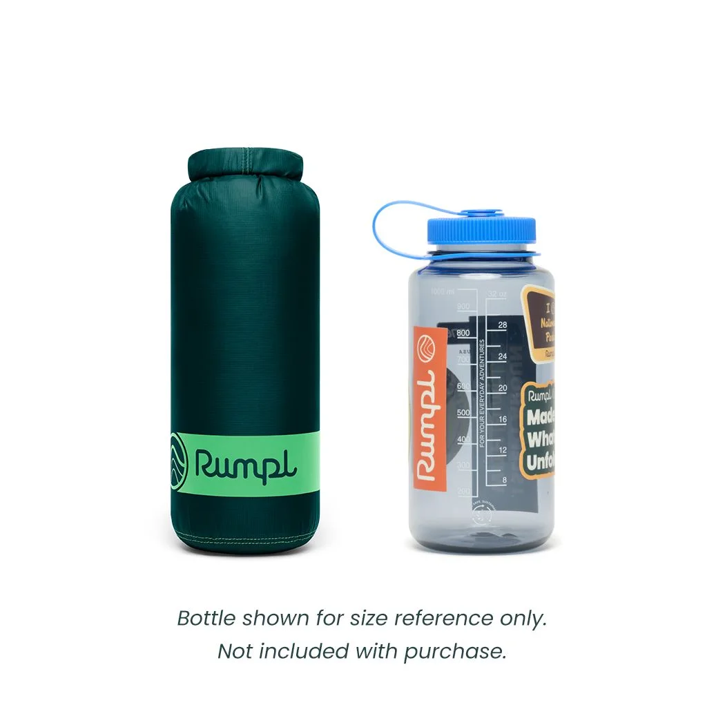 Packed blanket beside a bottle for scale; bottle not included.