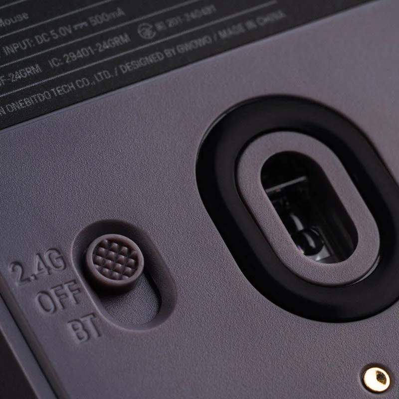 Dock close-up shows charging contacts and adapter-storage area.