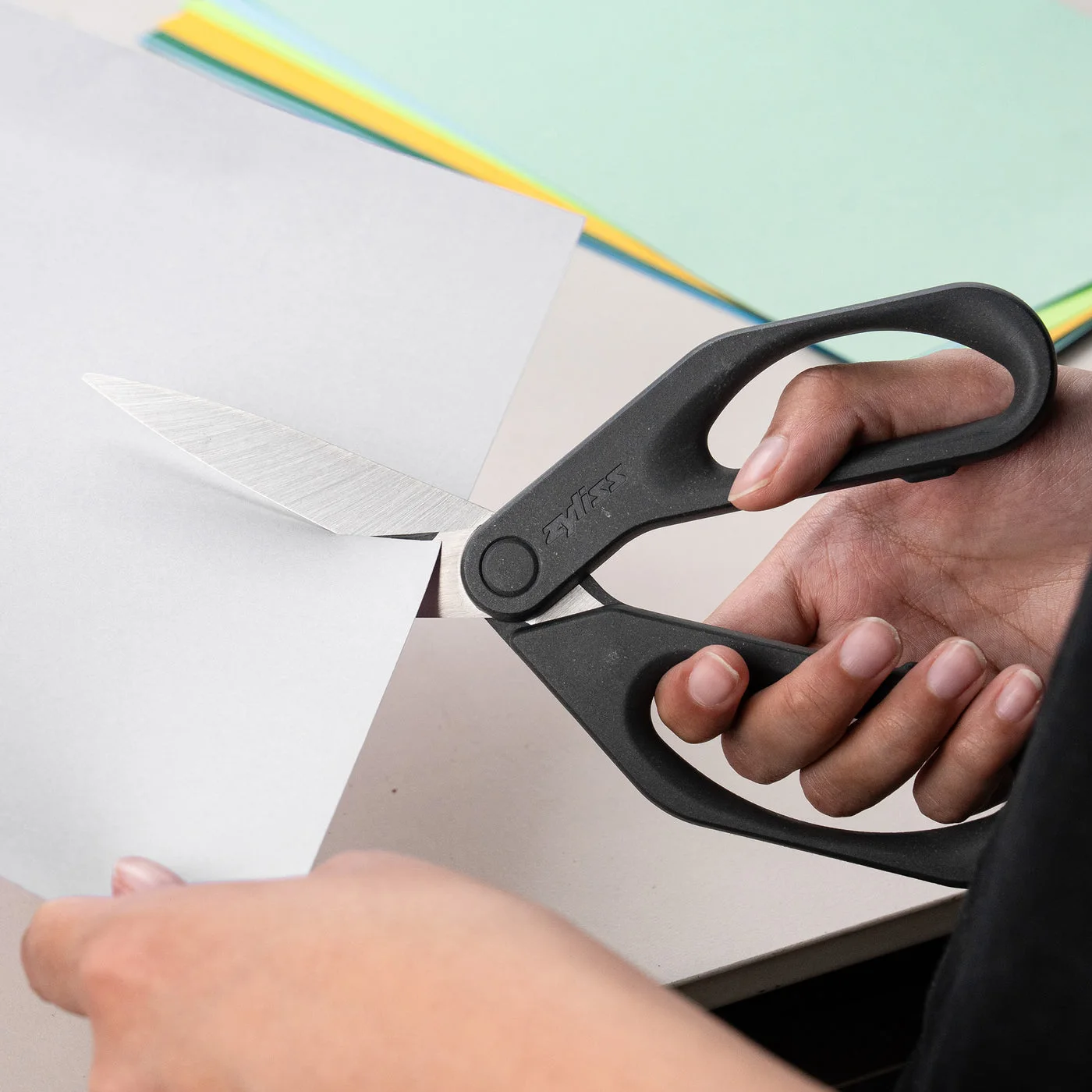 Blades cutting paper; paper and other tools are separate.