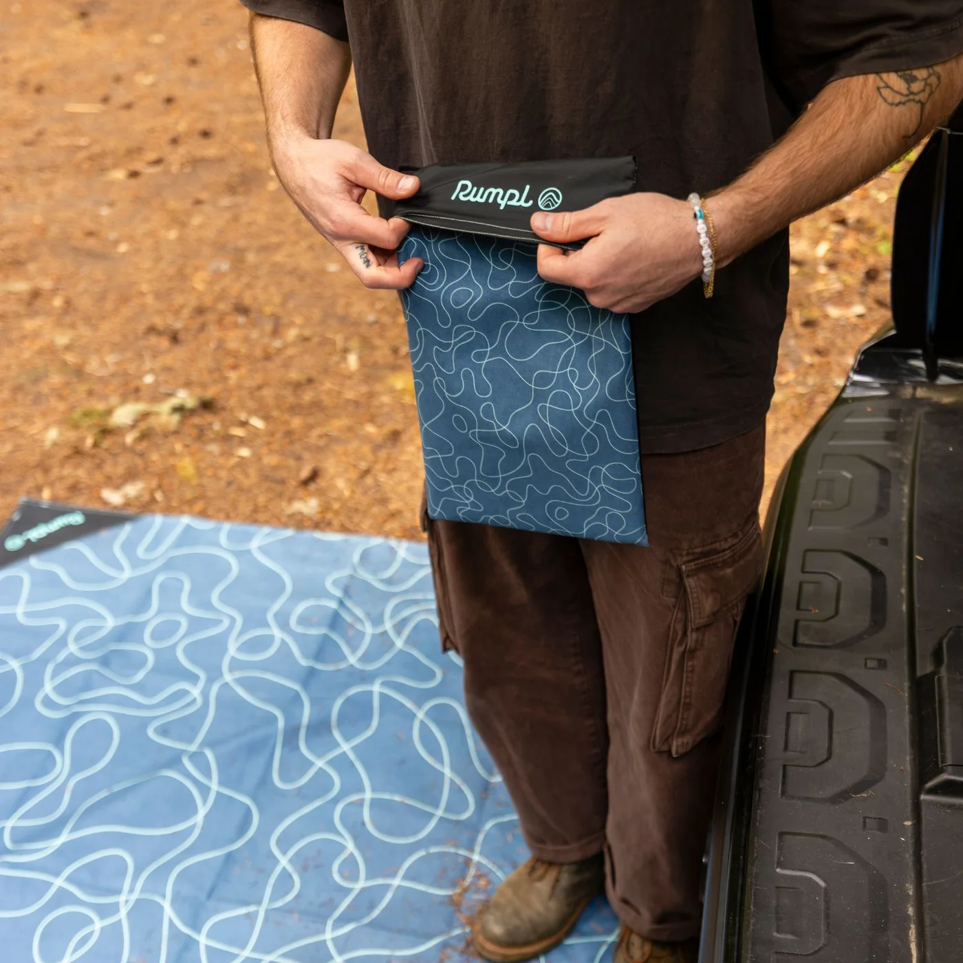 Selected mat being packed beside a vehicle.