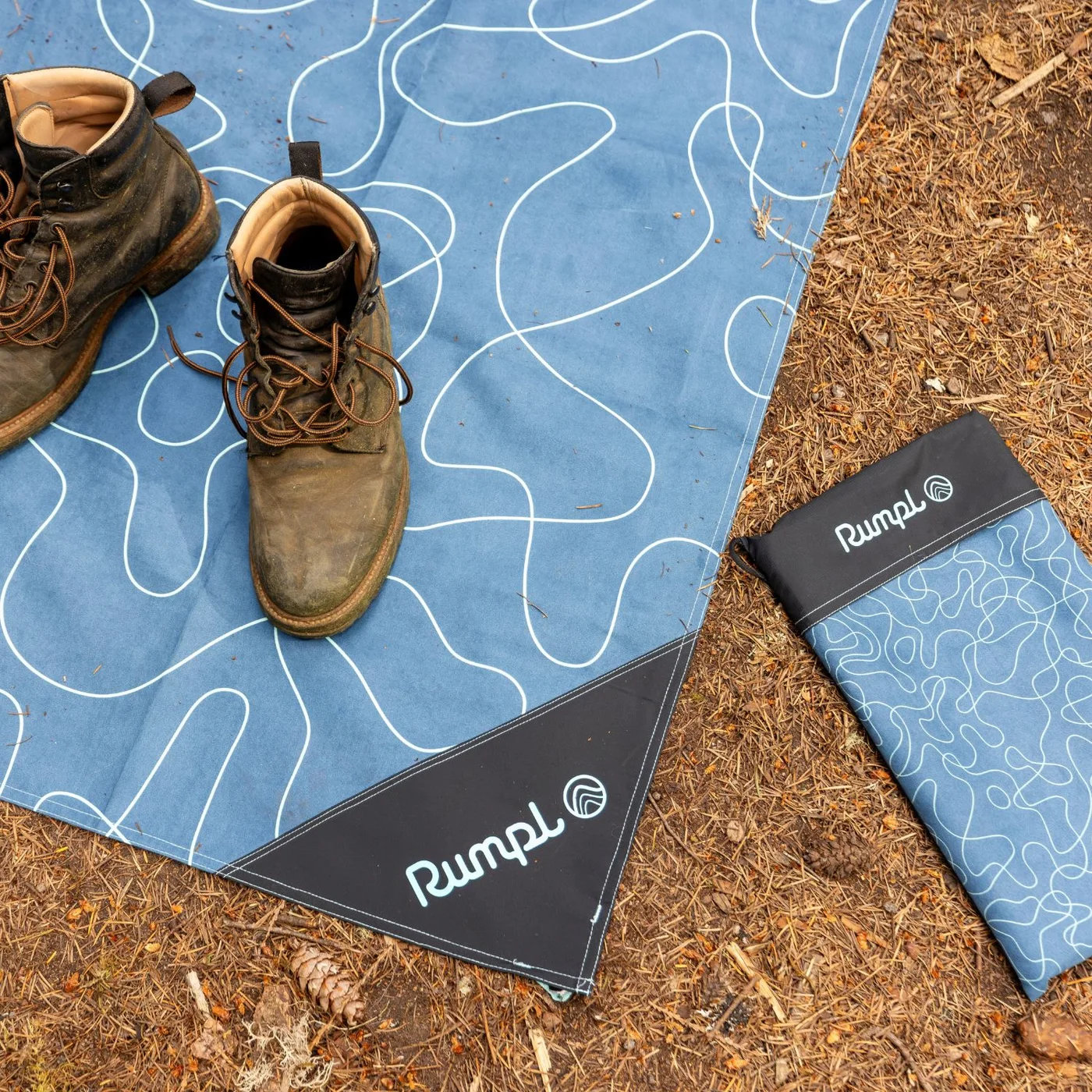 Staged ground mat arrangement with boots; props not included.