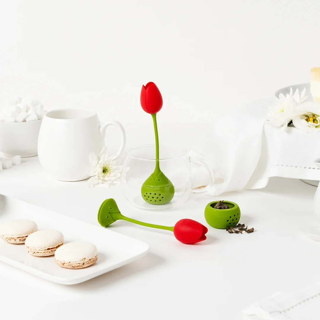 opened red Tulip beside tea set